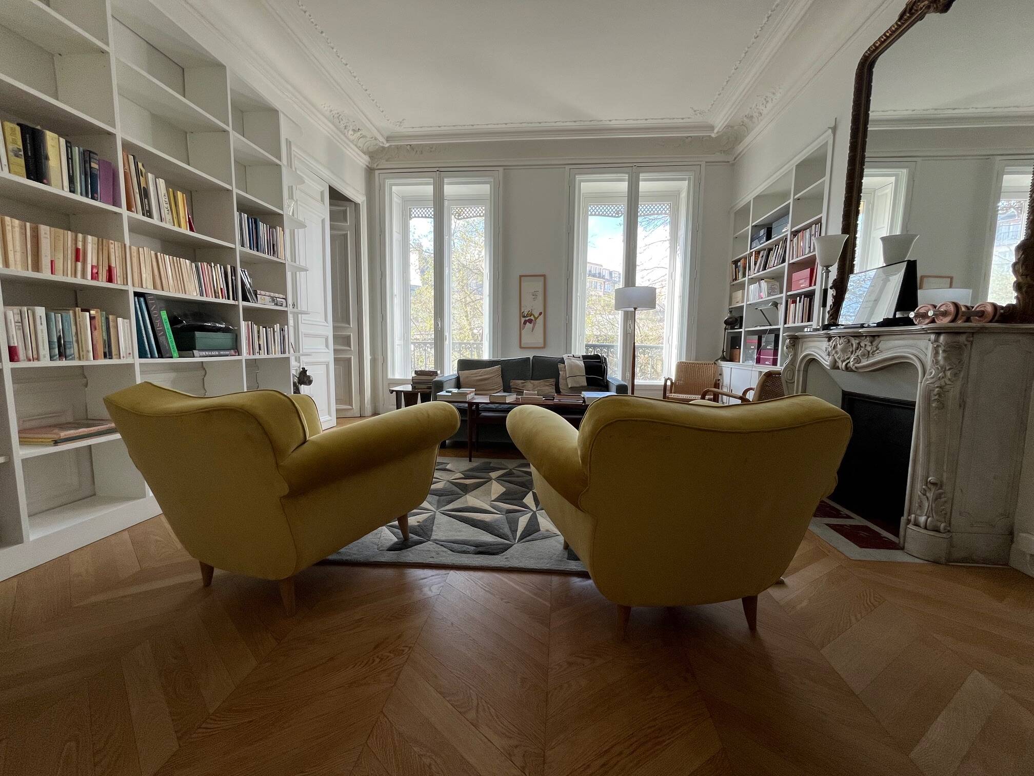 A pair of 1920s armchairs with an ottoman. Good condition.