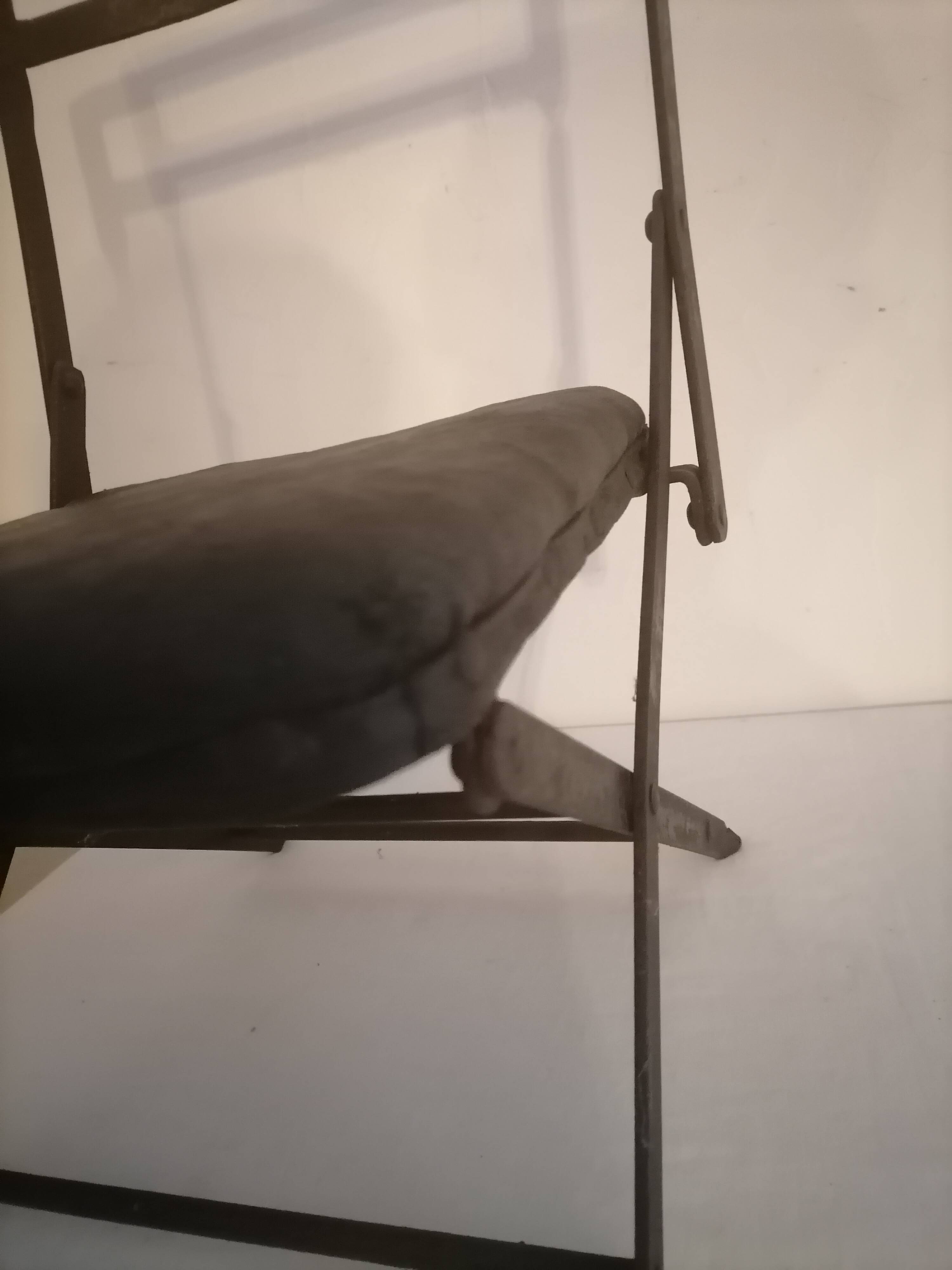 Old wrought iron folding children's chair. Early 20th century.