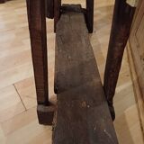 Small, very old, brutalist workbench equipped with a period workshop lamp