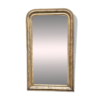 Very large Louis Philippe mirror with gold leaves.
