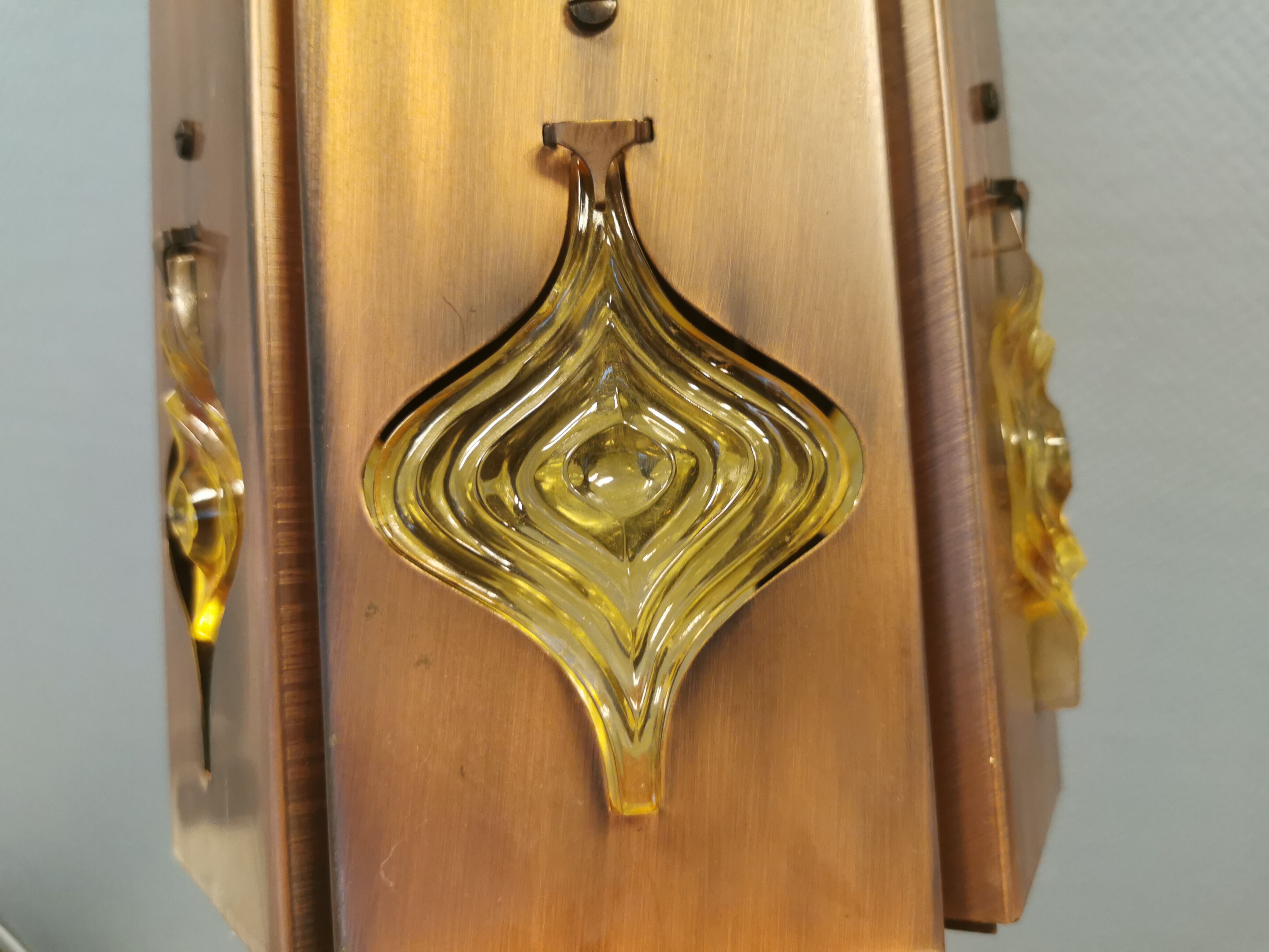 Older hanging lamp, made of metal with yellow prisms.