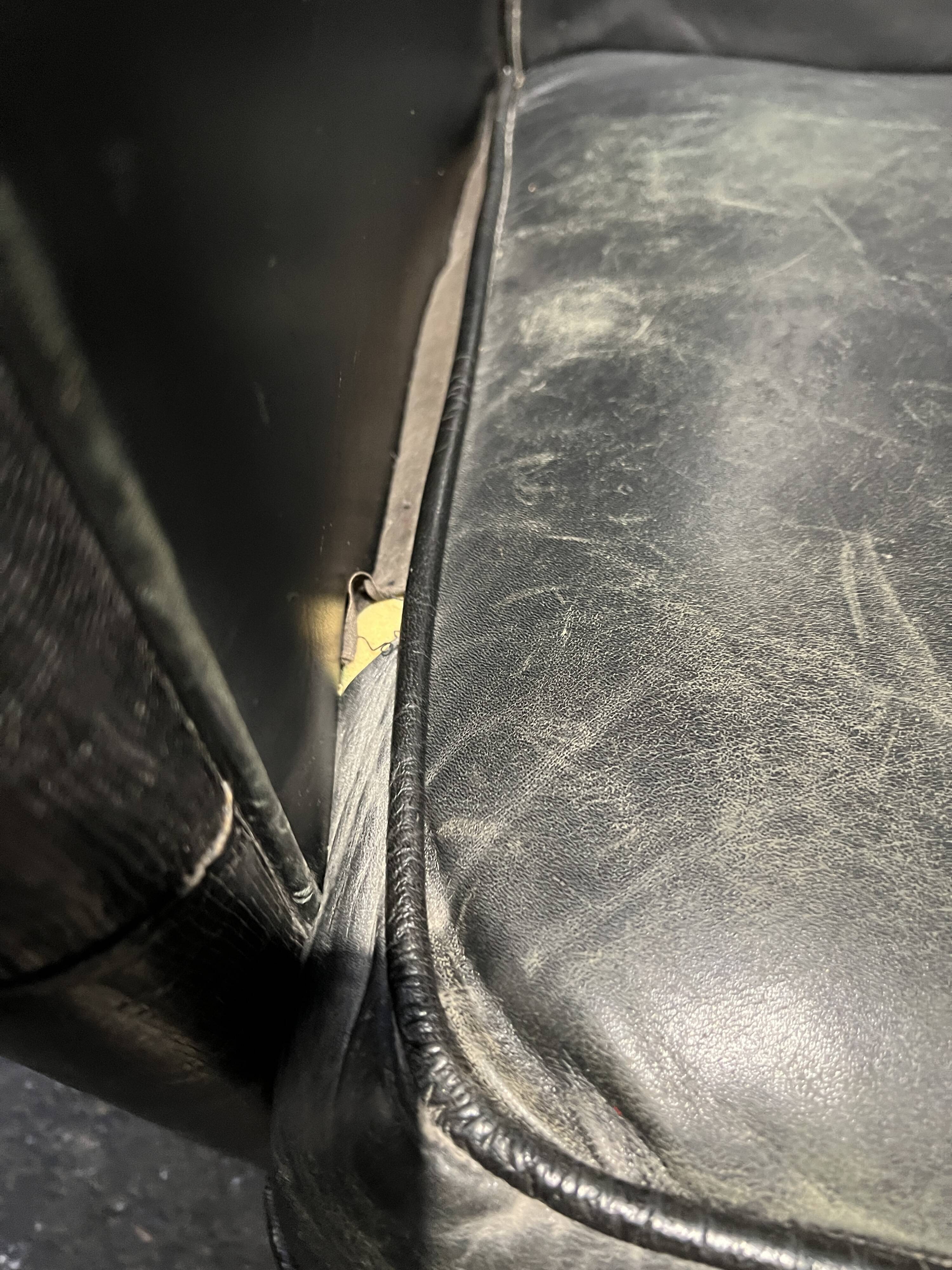 Pair of leather armchairs with marquetry armrests