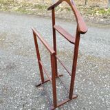 Valet wearing double wood coat rack