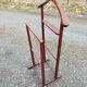Valet wearing double wood coat rack