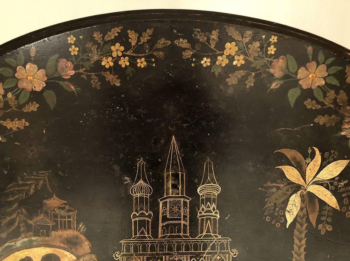 Large tilting pedestal table, black lacquered wood with a lively oriental landscape decoration.