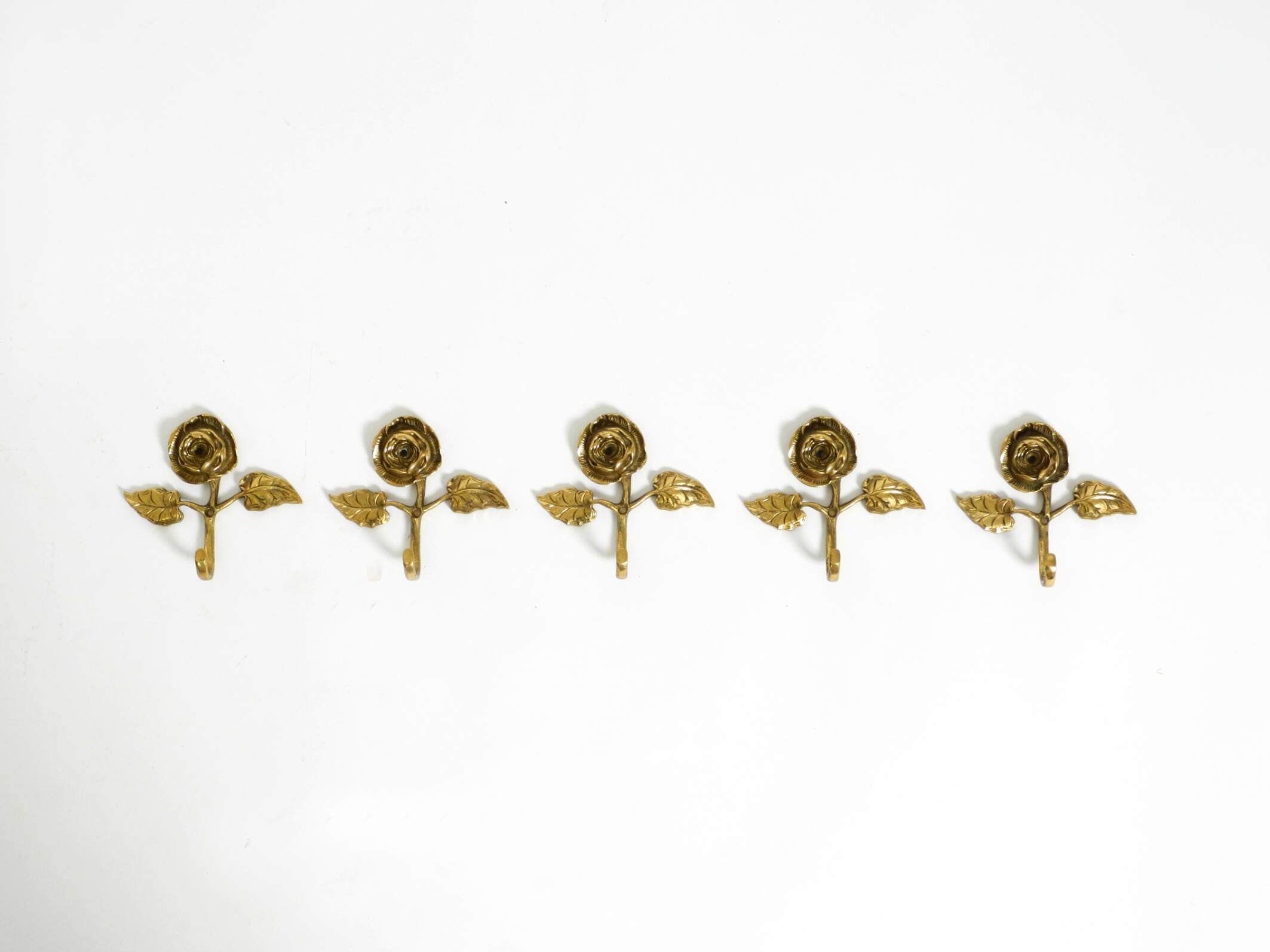 Set of five beautiful, solid mid-century brass rose wall coat hooks