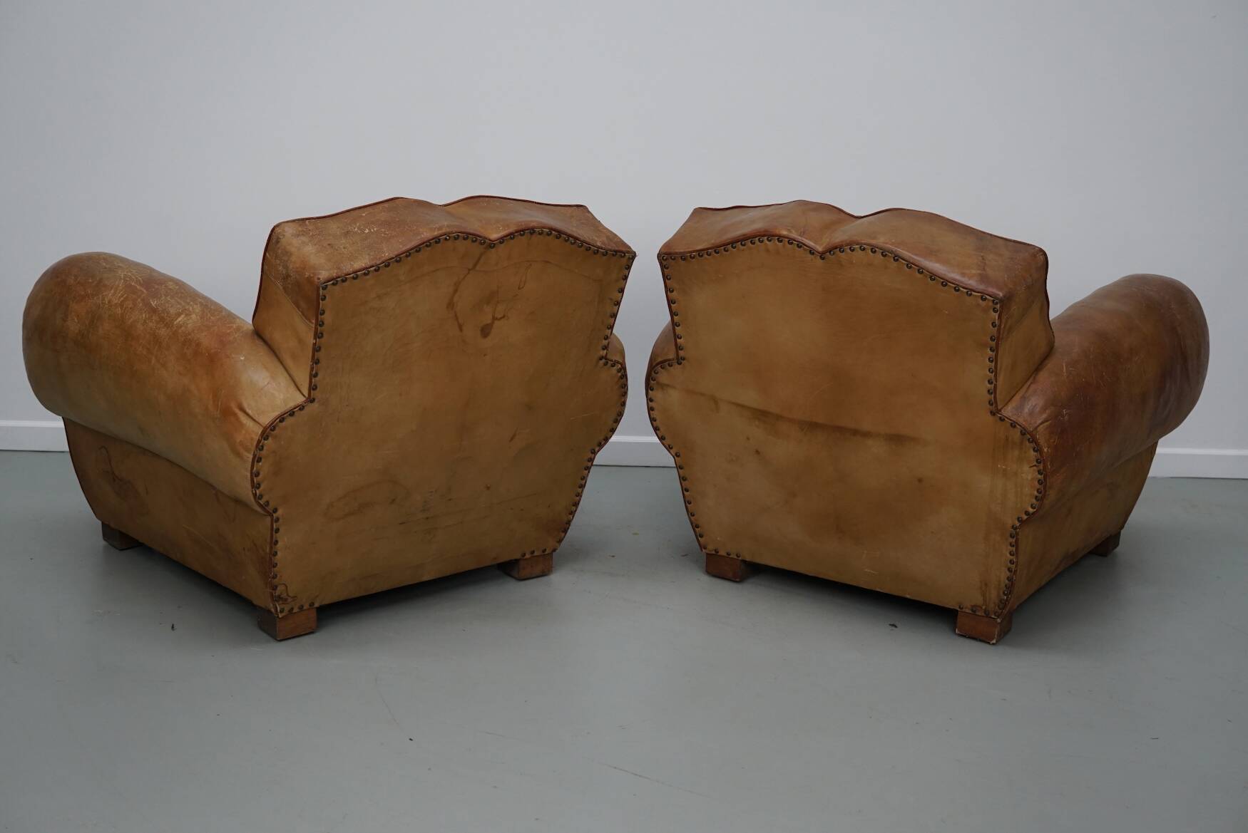 Pair of French club chairs with moustache back in cognac leather, 1940s
