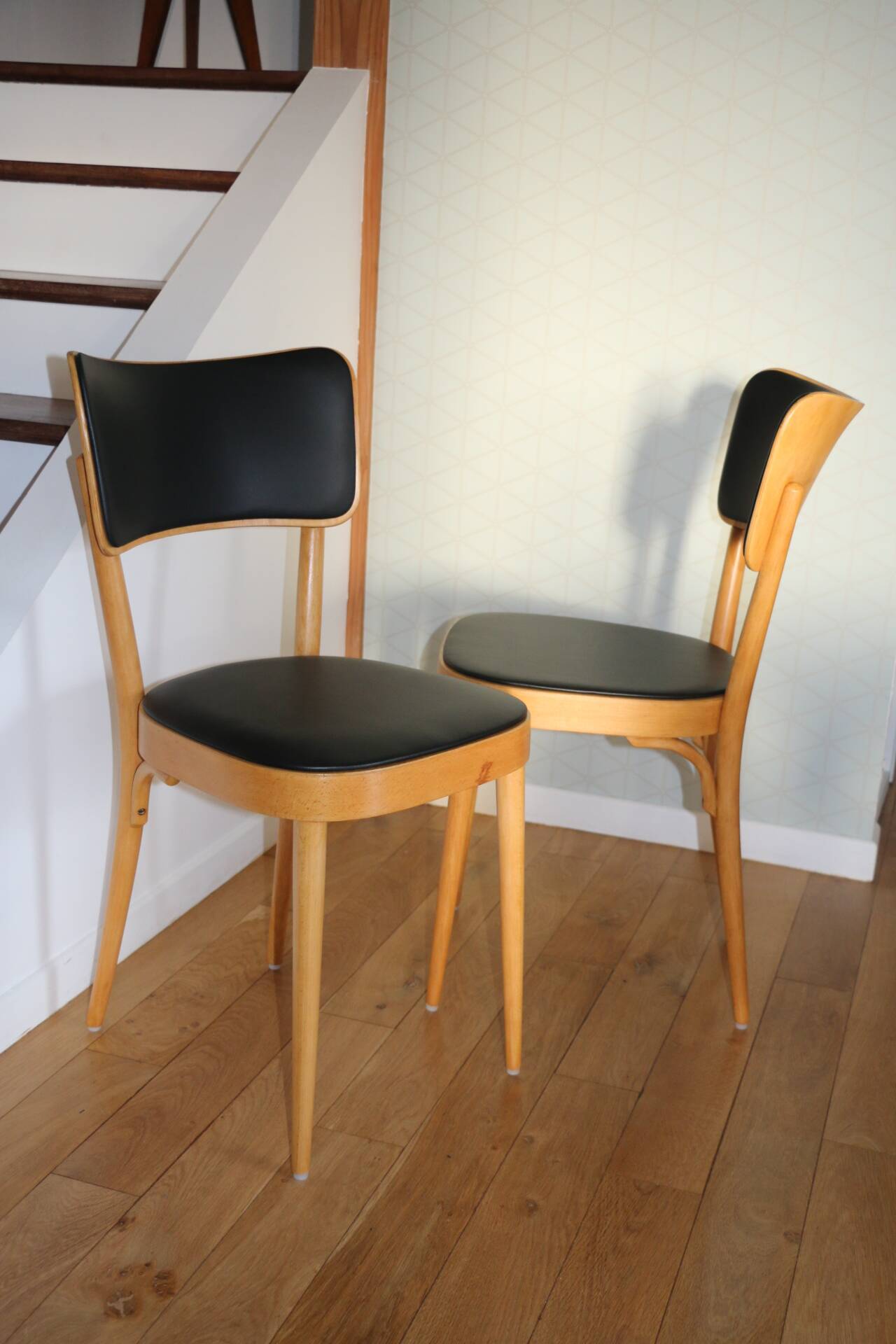 5 baumann chairs with large backs in black faux leather.