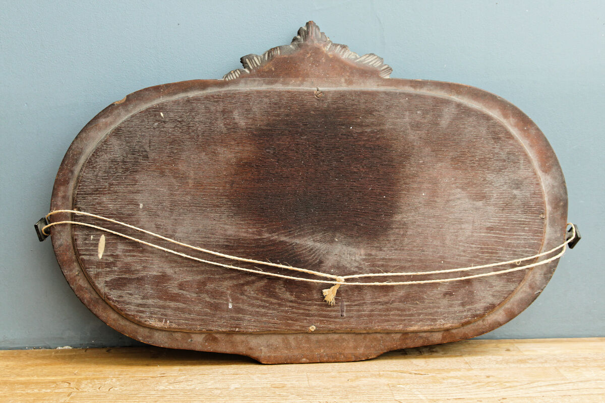 Beveled mirror in carved wood