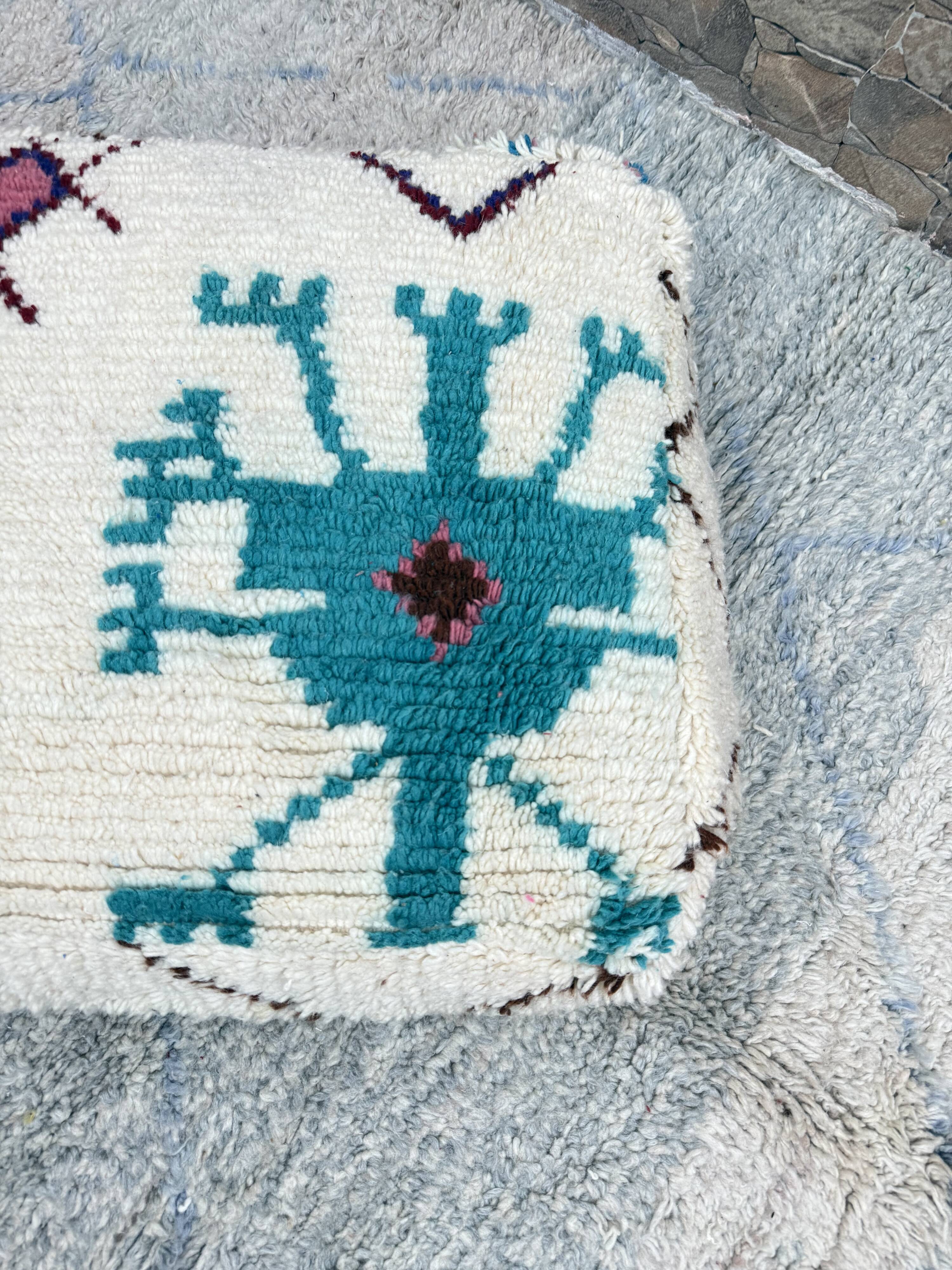 Berber floor pouf: Handwoven Moroccan wool cushion.