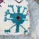Berber floor pouf: Handwoven Moroccan wool cushion.