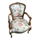 Louis XV style armchair upholstered in floral fabric.