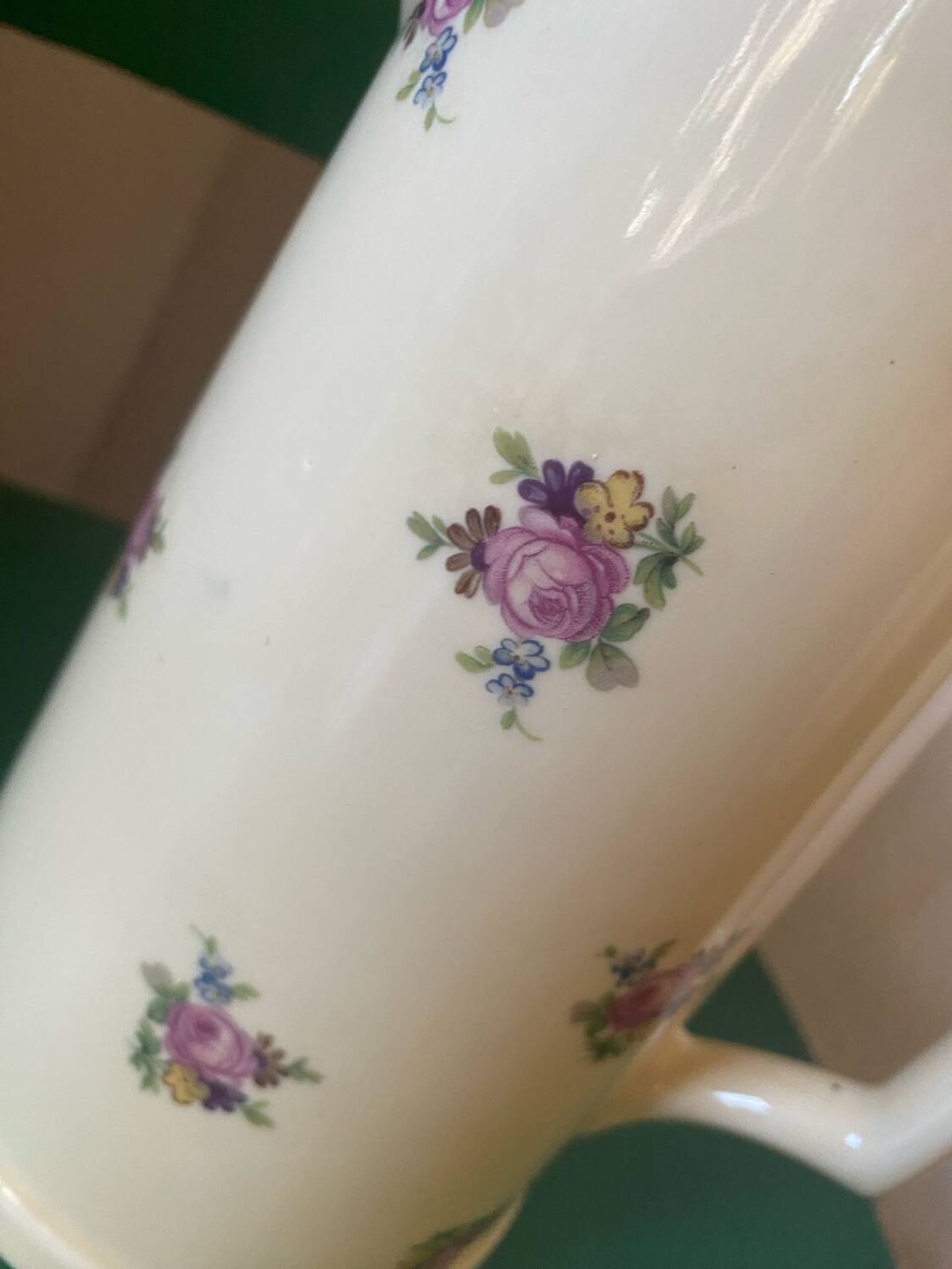 Old flowery and gilded pitcher.