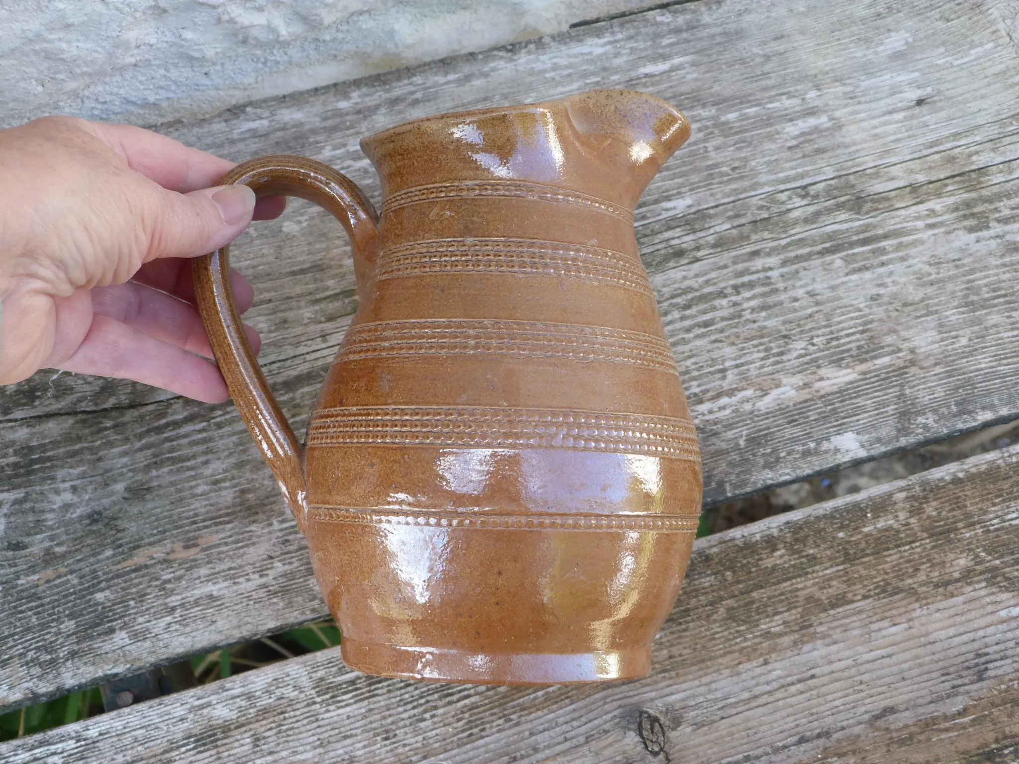 Old stoneware wine jug with patterns