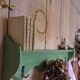 Antique wall shelf with a green patina