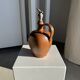Ancient stoneware jug with a pewter spout.