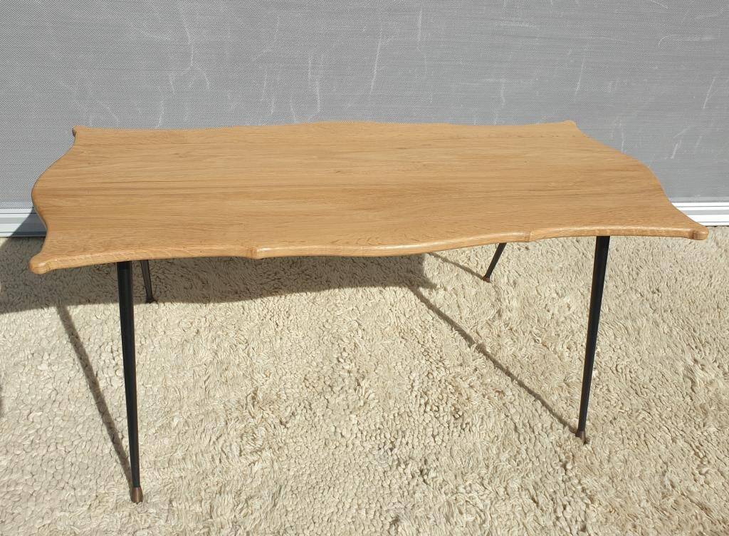 Violin-shaped coffee table with brass legs