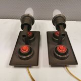 A set of Vitrika Denmark, cast iron wall lights with red details.