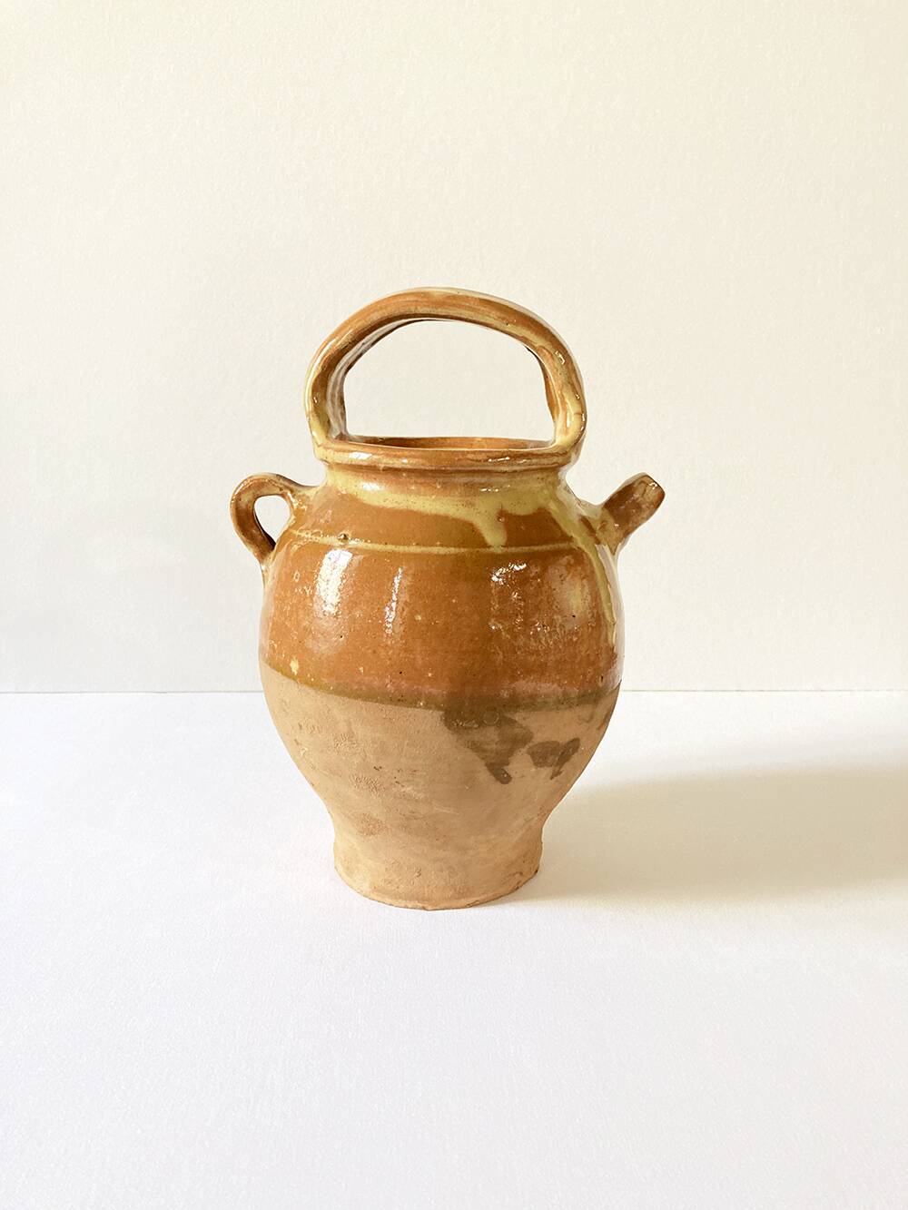 Old ochre and yellow glazed ceramic jug / goat