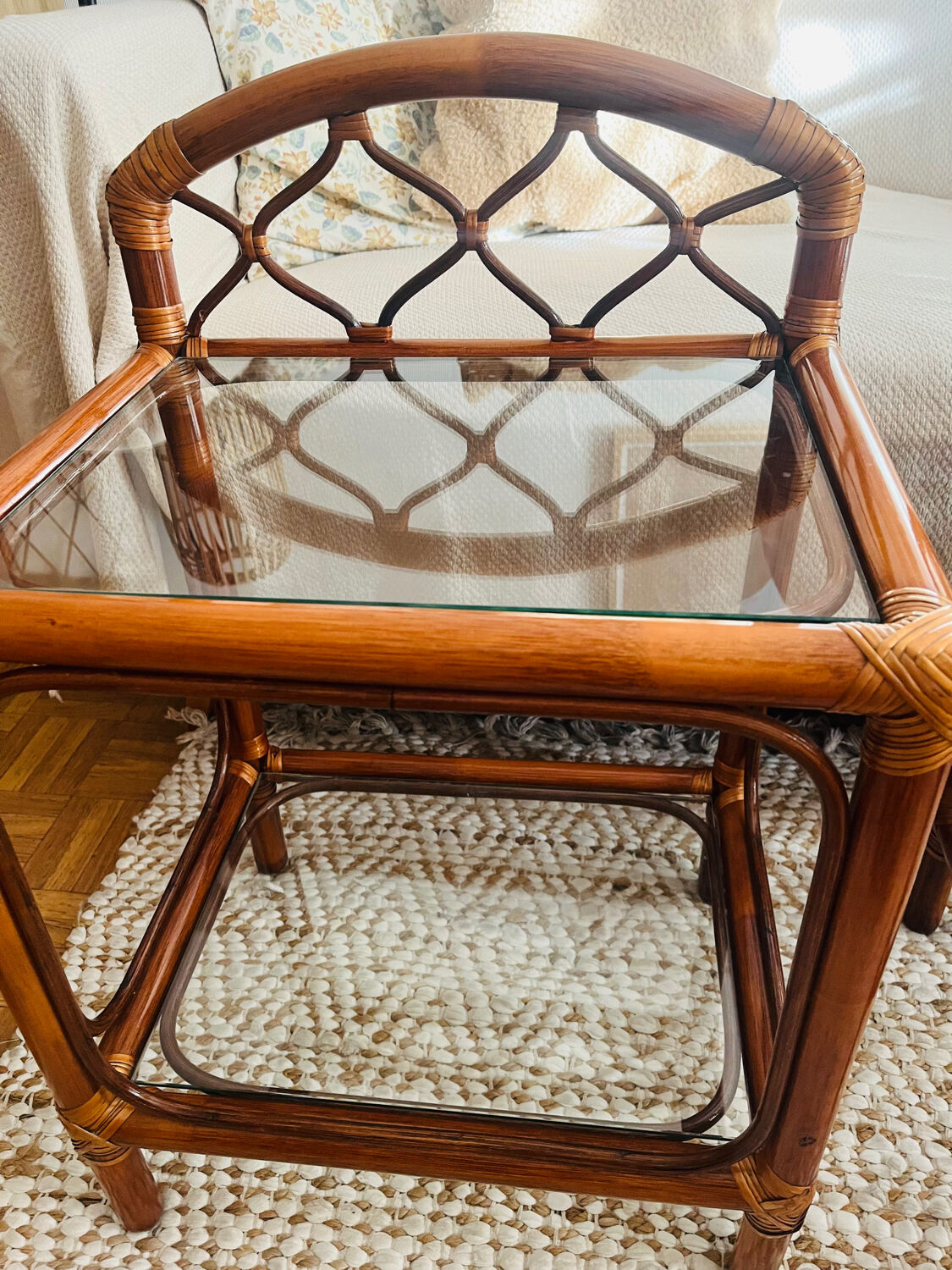 Two rattan and glass bedside tables