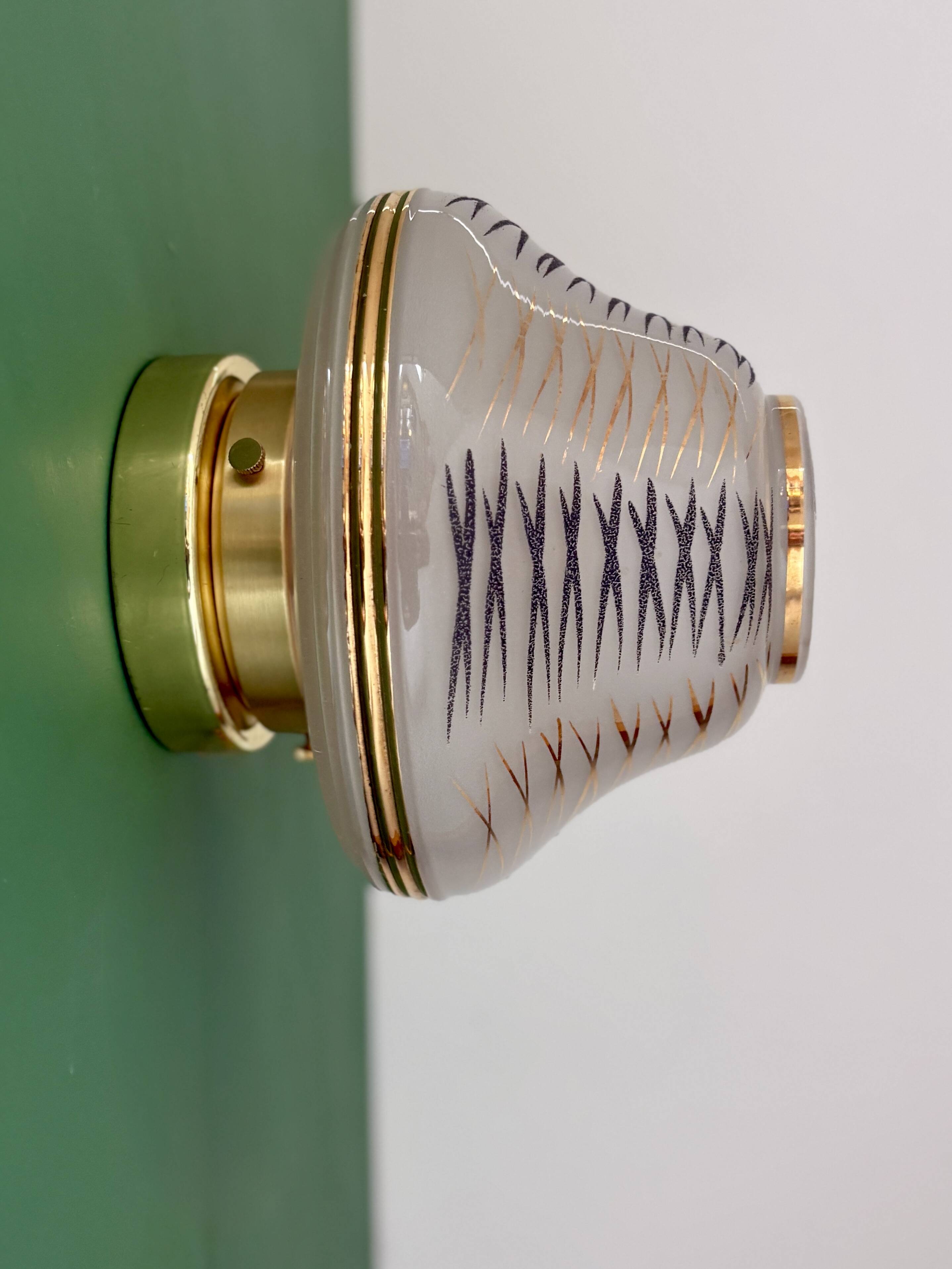 Vintage Art Deco globe wall/ceiling light in white, black, and gold glass.