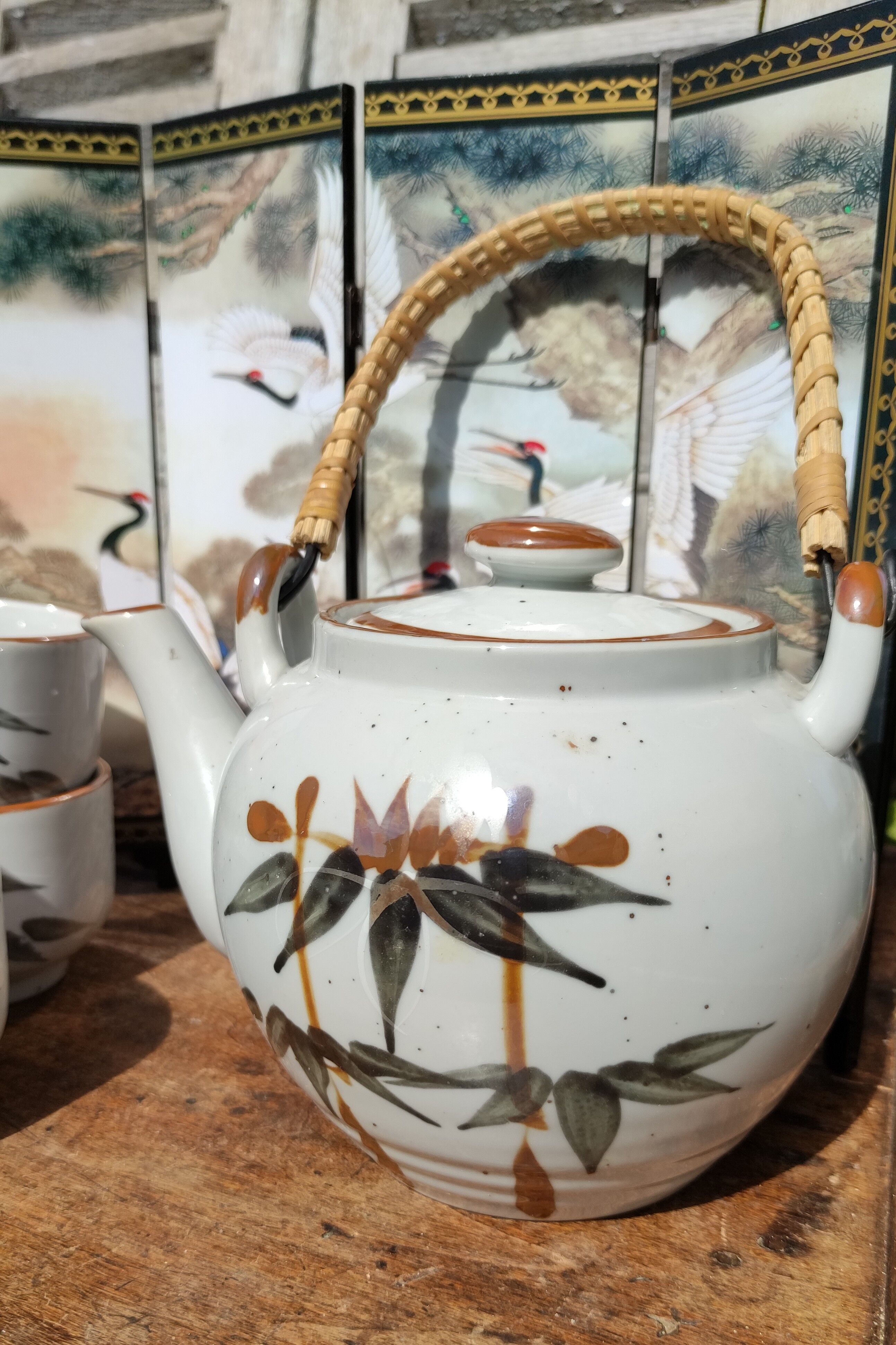 Asian set of a teapot and its cups