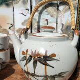 Asian set of a teapot and its cups