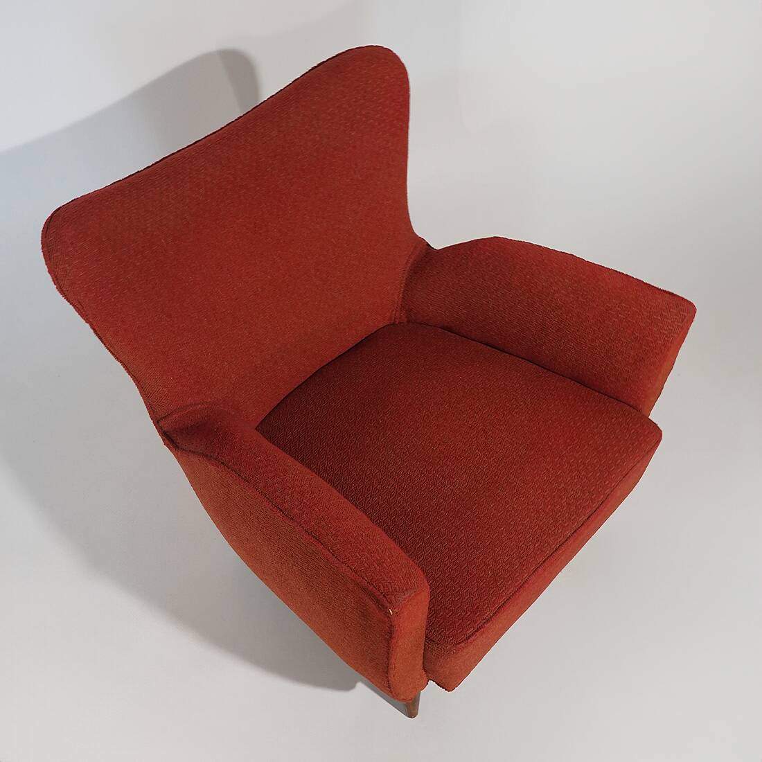 Pair of red armchairs with cone-shaped feet, 1950s
