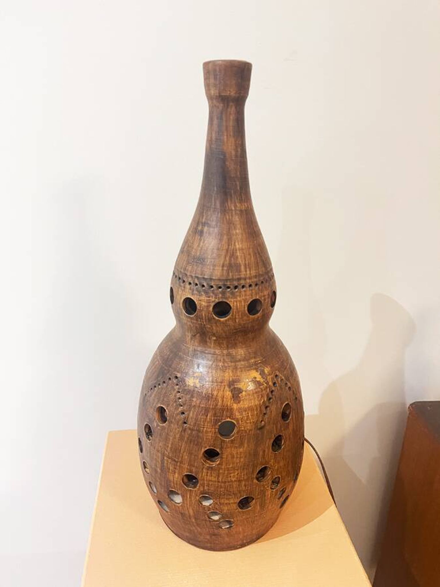 Terracotta lamp with cut-outs, circa 1970.