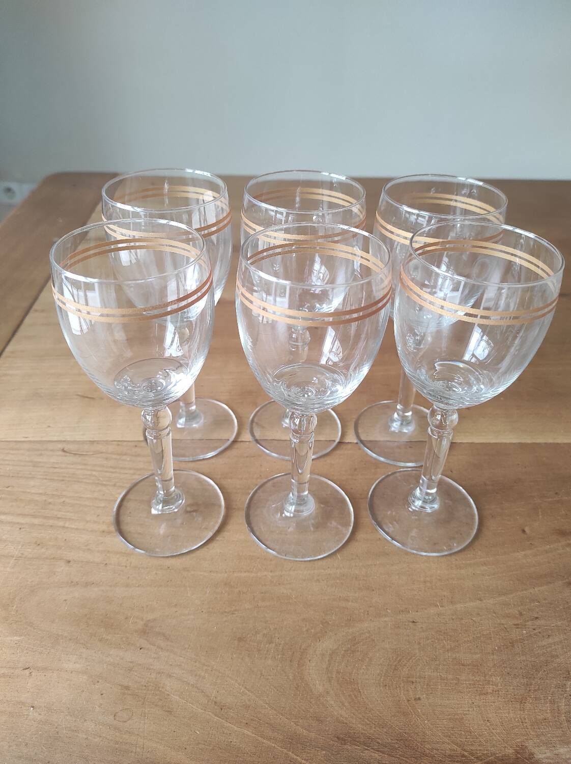 Set of 6 glasses with gold band decorations.