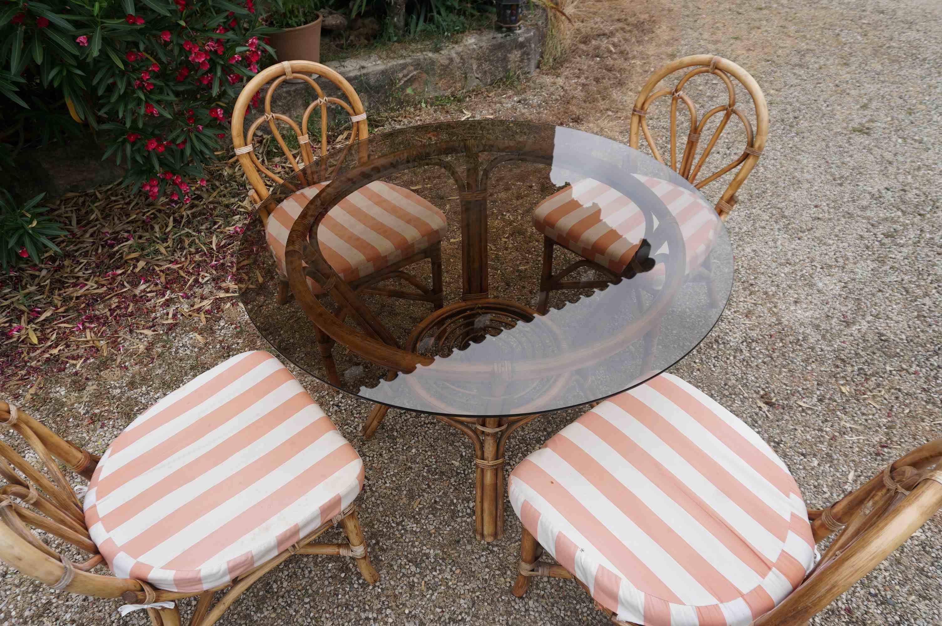 dining table and chairs made of curved bamboo and rattan with smoked glass from the 1970s