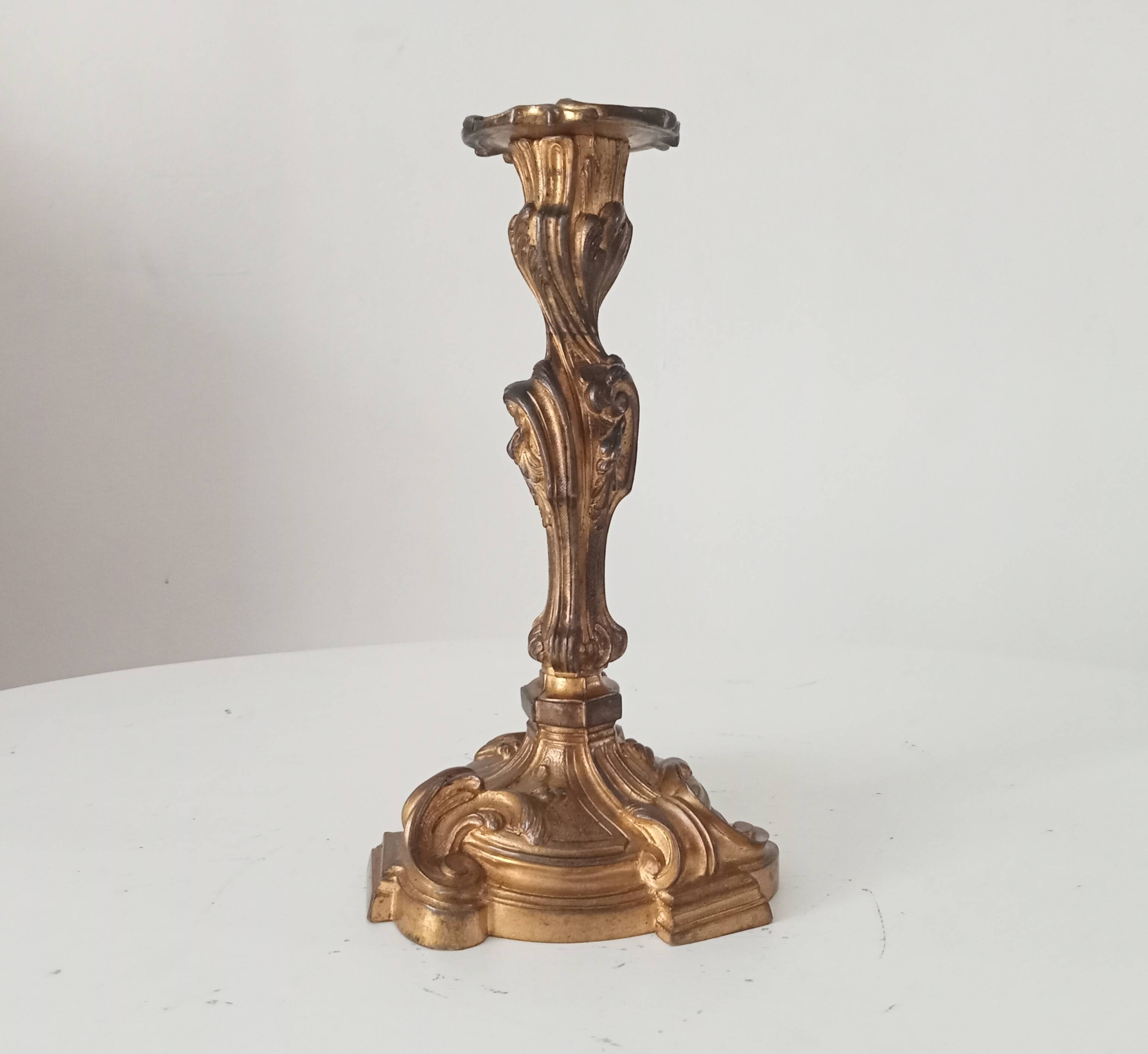 Antique 19th-century solid gilded bronze candlestick in the Louis XV style.