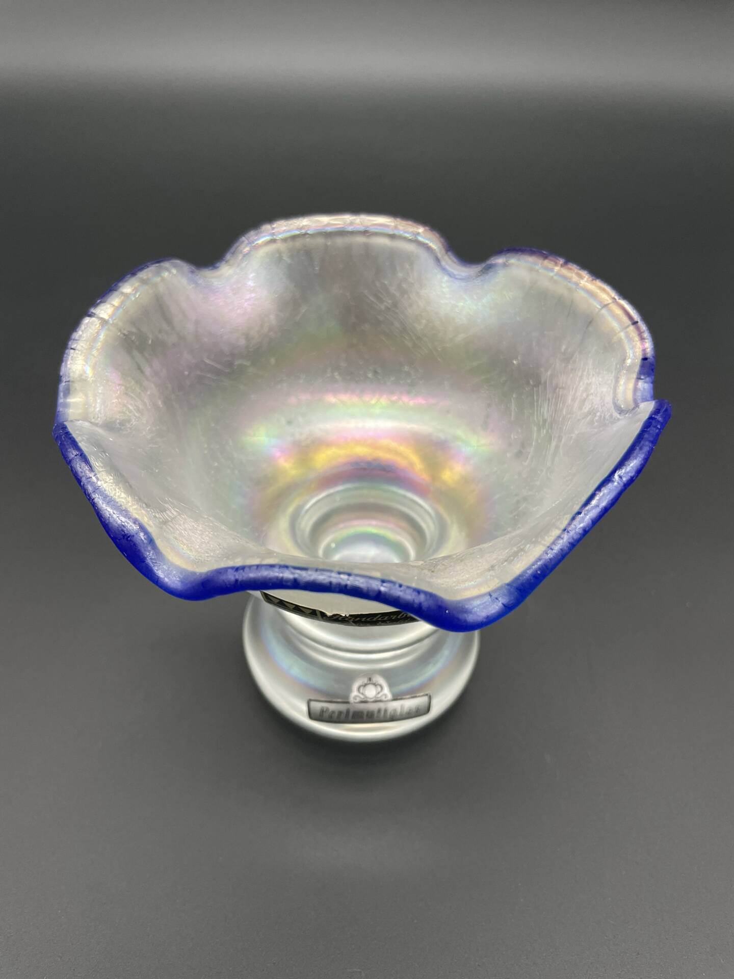 Eisch glass footed cup with pearlescent finish, blue rim.