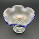 Eisch glass footed cup with pearlescent finish, blue rim.