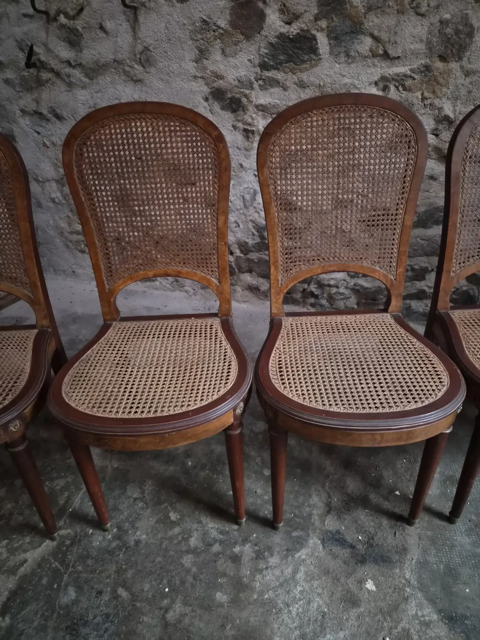 Set of 6 antique Louis XVI style dining chairs with caning.