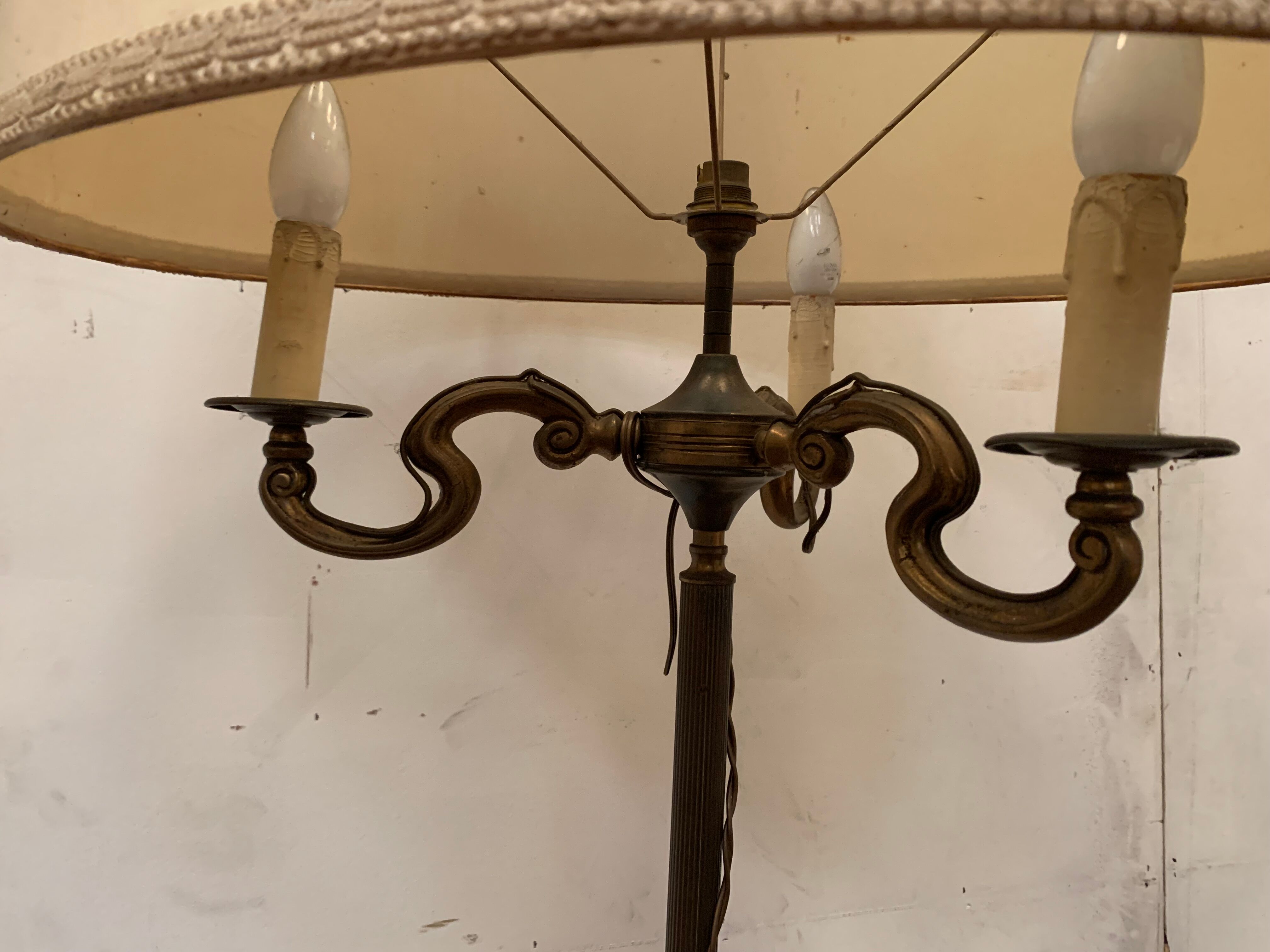 Floor lamp has three brass light arms