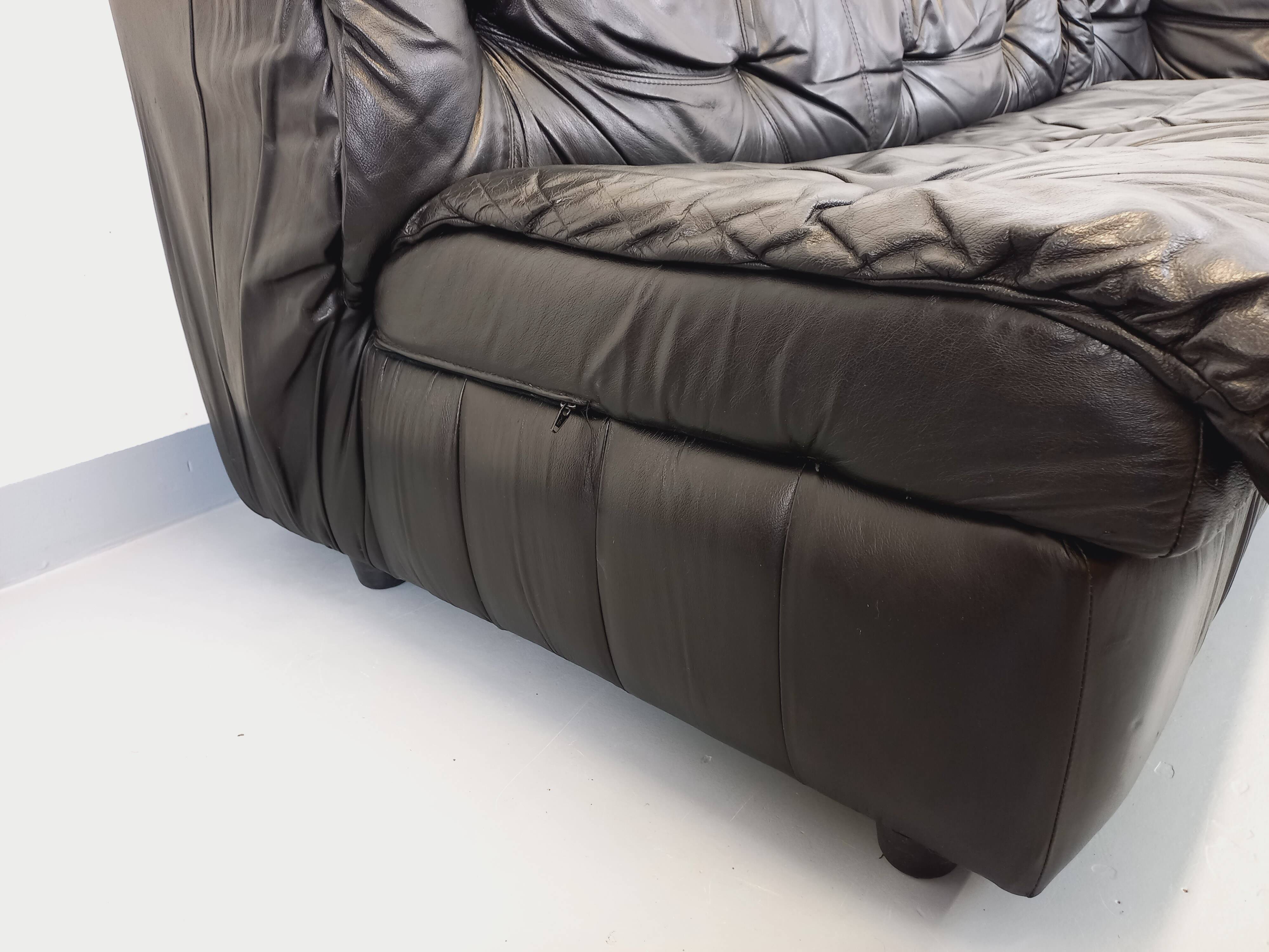 Vintage corner sofa composed of 3 modules in black leather with integrated bed.
