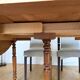 Walnut table with 6 legs and 2 extensions.