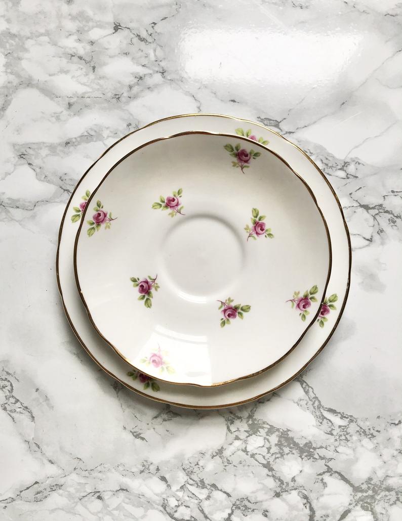 Teacup on its saucer and porcelain cake plate