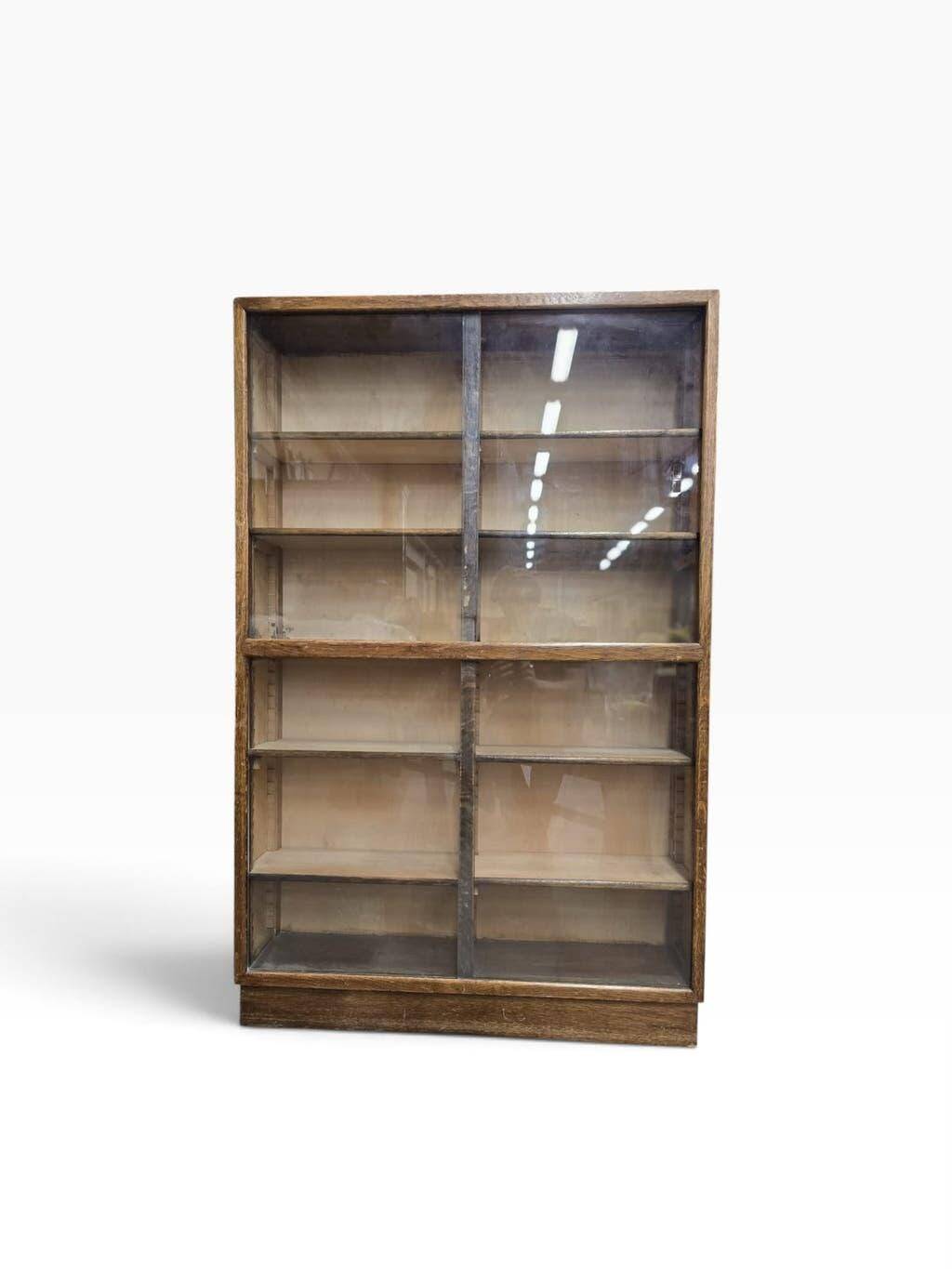 Vintage shallow wooden display shelf with sliding glass doors.