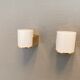 Wall lamps with milky white acrylic plastic shades and solid brass bases