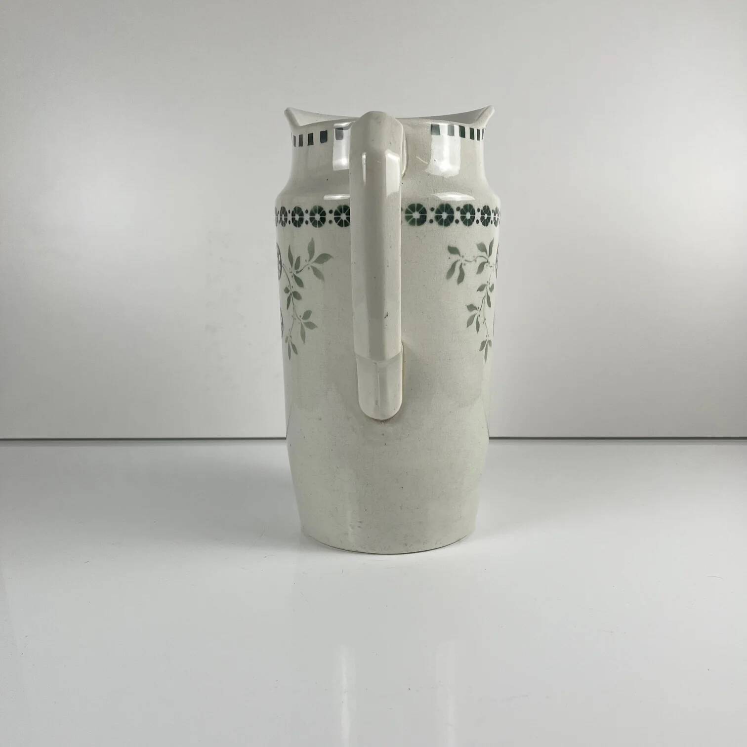 Antique earthenware pitcher, green floral decoration, fine ironstone from the late 19th to early 20th century.