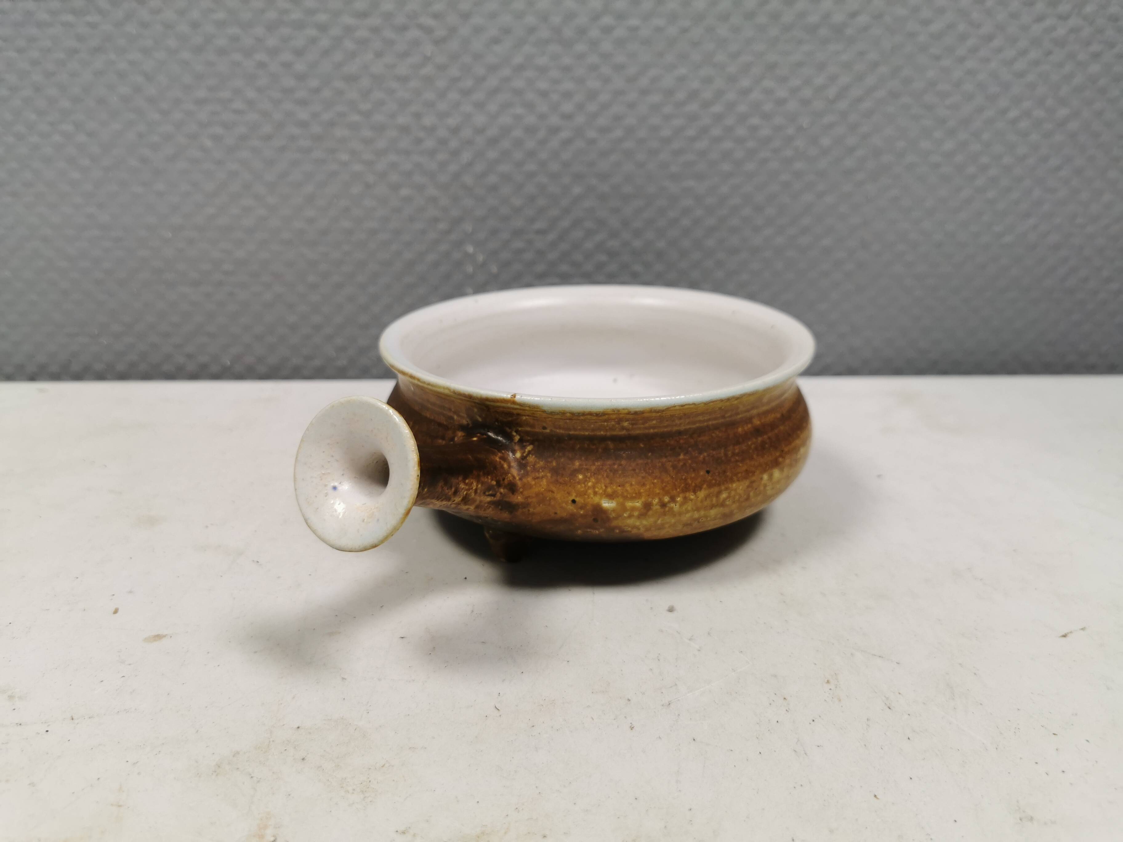 Small ceramic bowl with handle, in golden colours. Danish 1960-70s