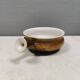 Small ceramic bowl with handle, in golden colours. Danish 1960-70s
