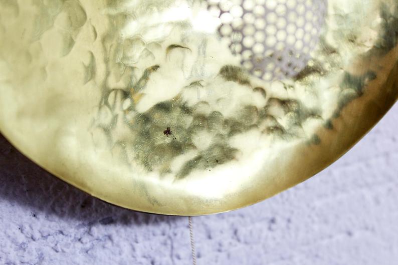 Hammered brass and perforated metal sconce