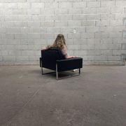 Pair of black leather armchairs