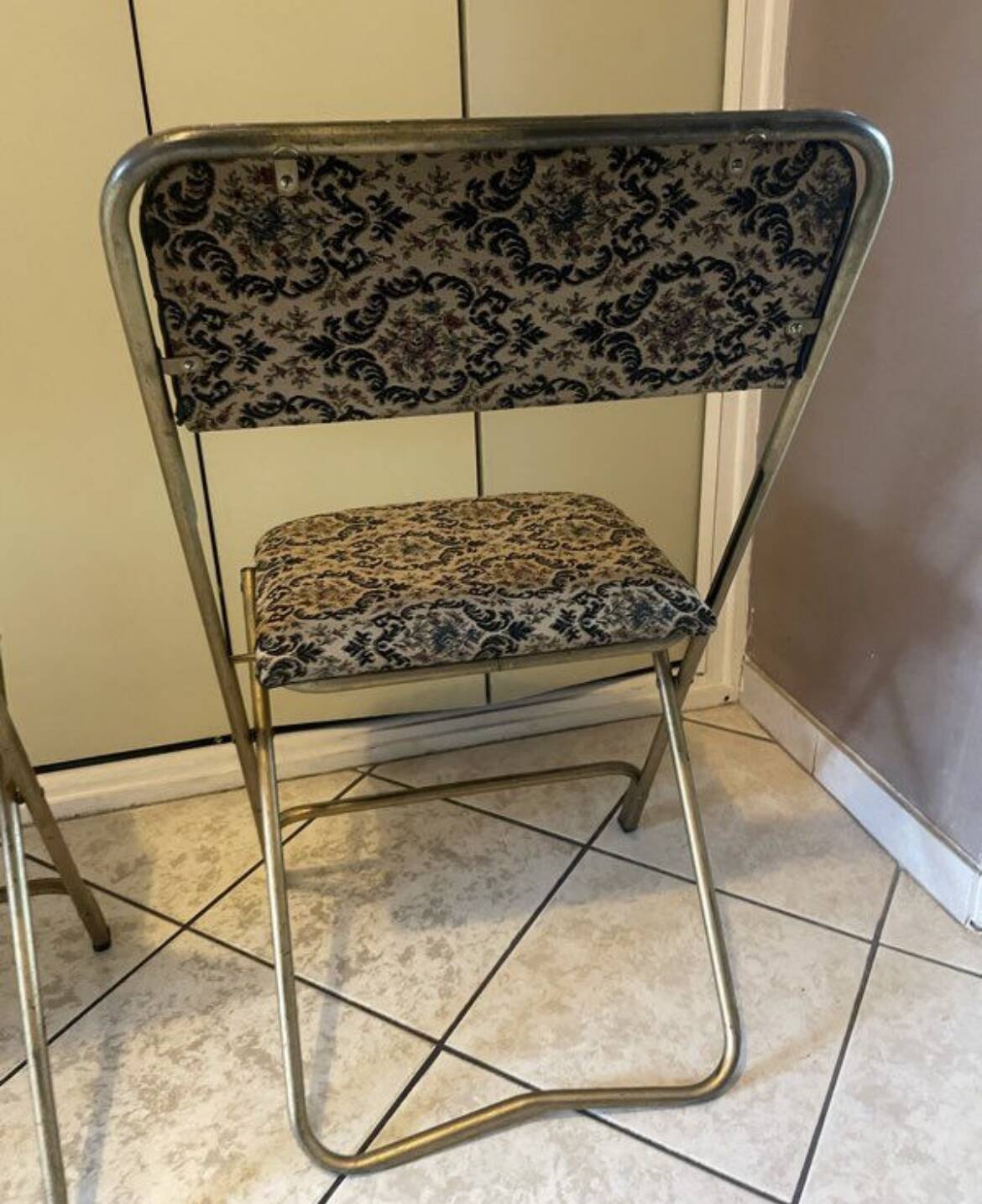 Two antique Manufrance folding chairs in metal and fabric