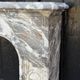 Louis XV fireplace in grey Ardennes marble, a floral basket in white marble, late 18th century.