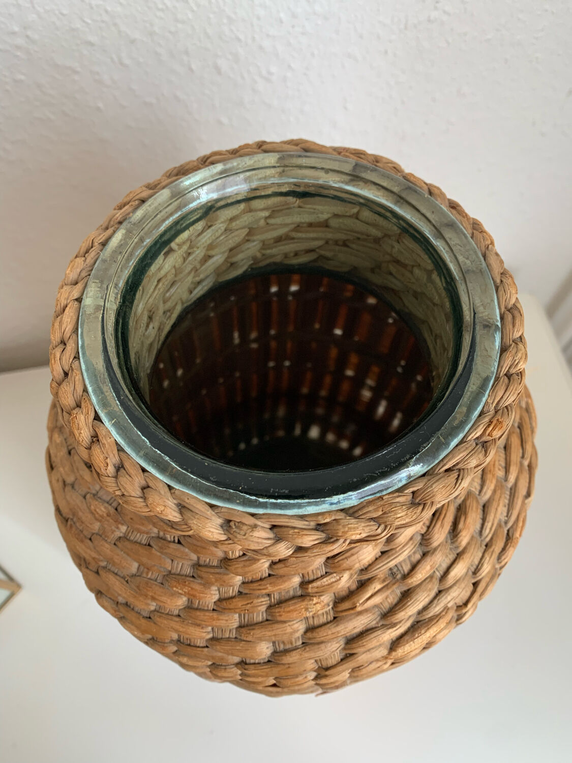 Green glass jar with wickerwork