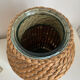 Green glass jar with wickerwork